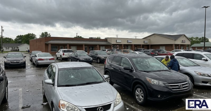 Hail damaged cars in Owensboro Kentucky parking lot showing why auto insurance rates are rising