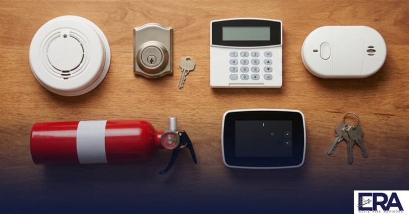 Overhead flat lay of home protection items including smoke detector deadbolt lock and security keypad — 7 ways to save on homeowners insurance in Kentucky