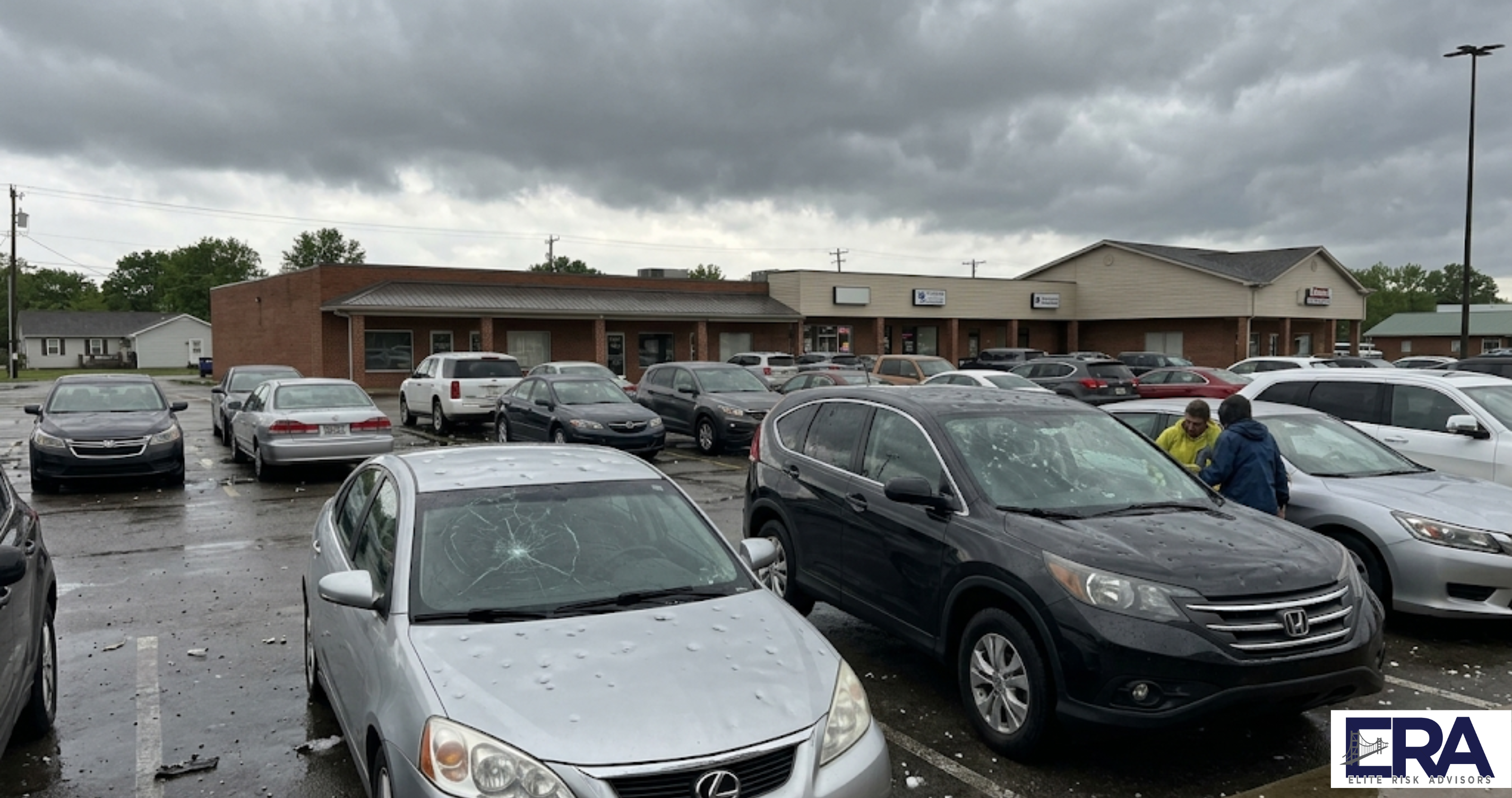 Hail damaged cars in Owensboro Kentucky parking lot showing why auto insurance rates are rising